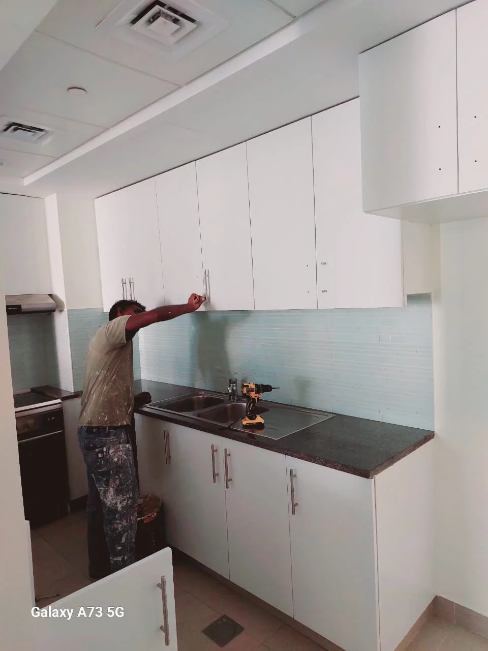 man renovating the kitchen of villa